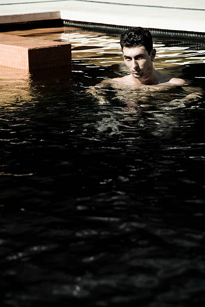 young man in modern swimming pool