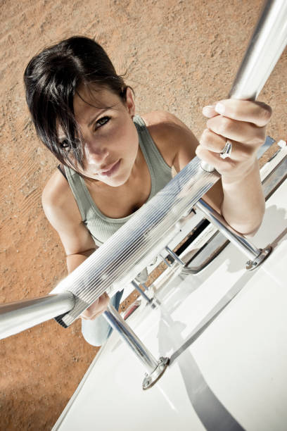 Attractive Sporty Woman Climbing Up.