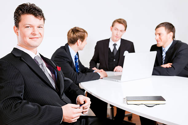 Smiling Businessman at the Team Meeting