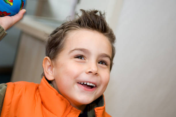 Child Laughing, Throwing Ball