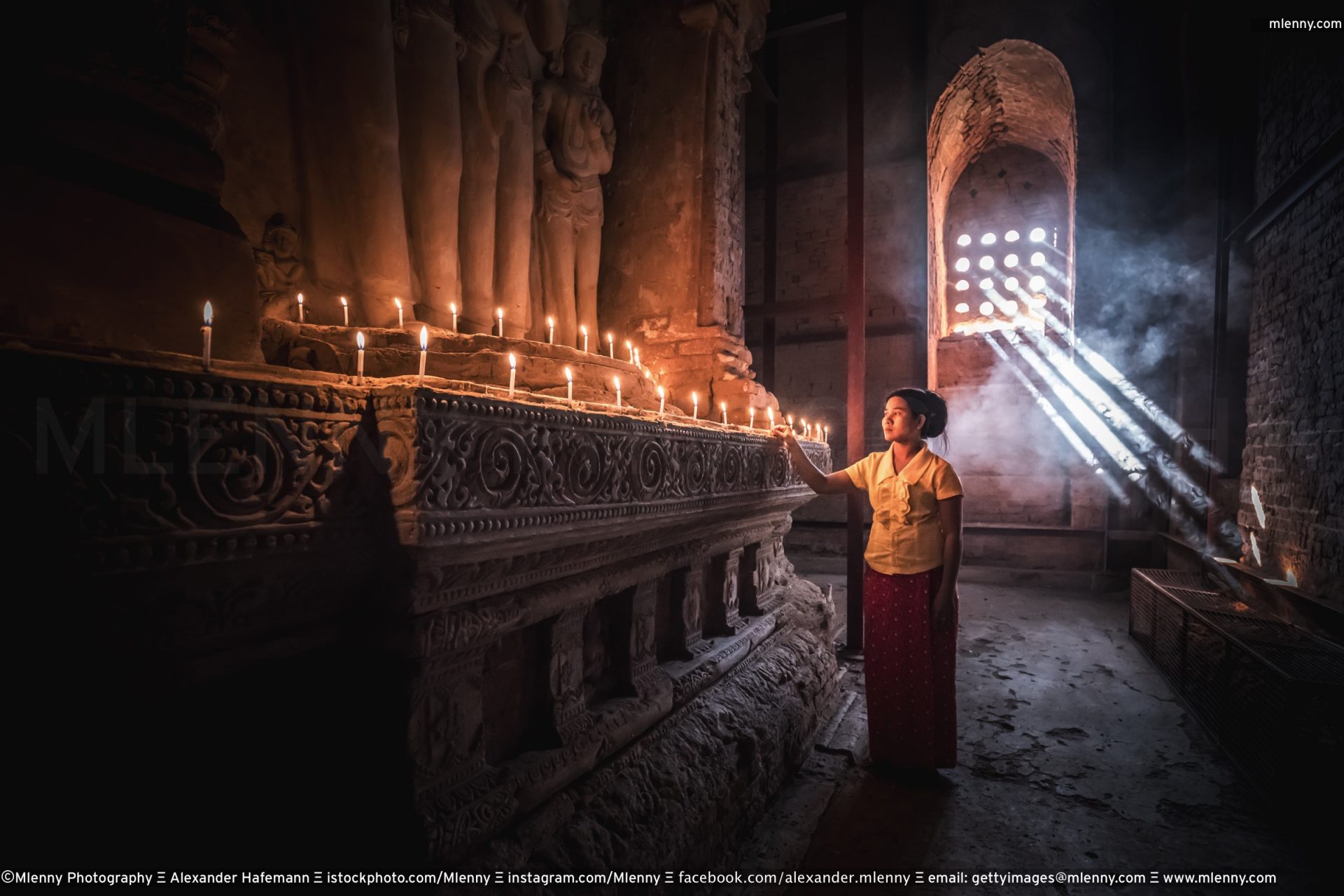Burmese woman worshipping Buddha. Old Bagan, Myanmar