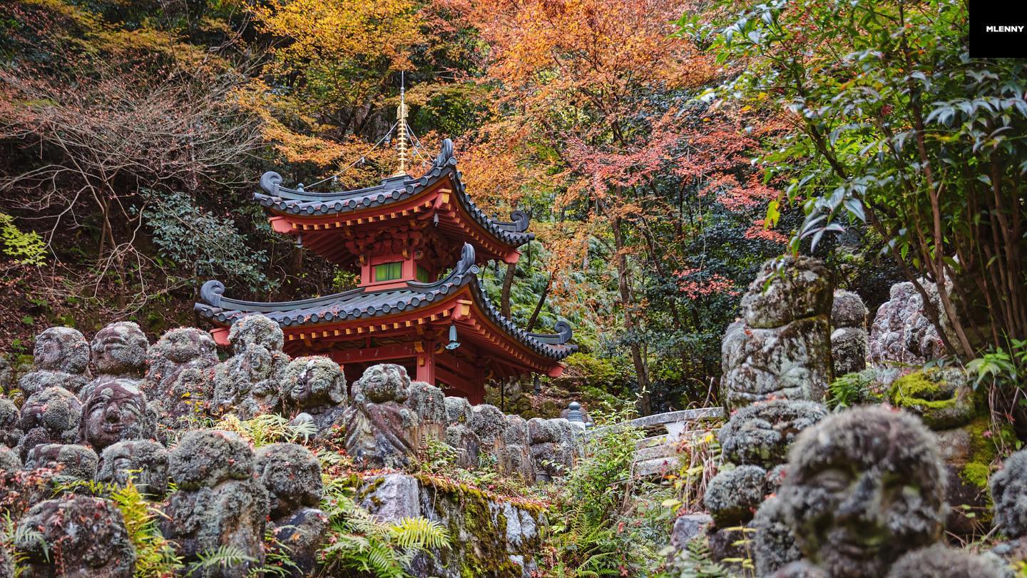 Kyoto Autumn Panorama. Buddhist Temple Pagoda surrounded with hundreds of whimsical moss covered, weathered stone figures representing Rakan.