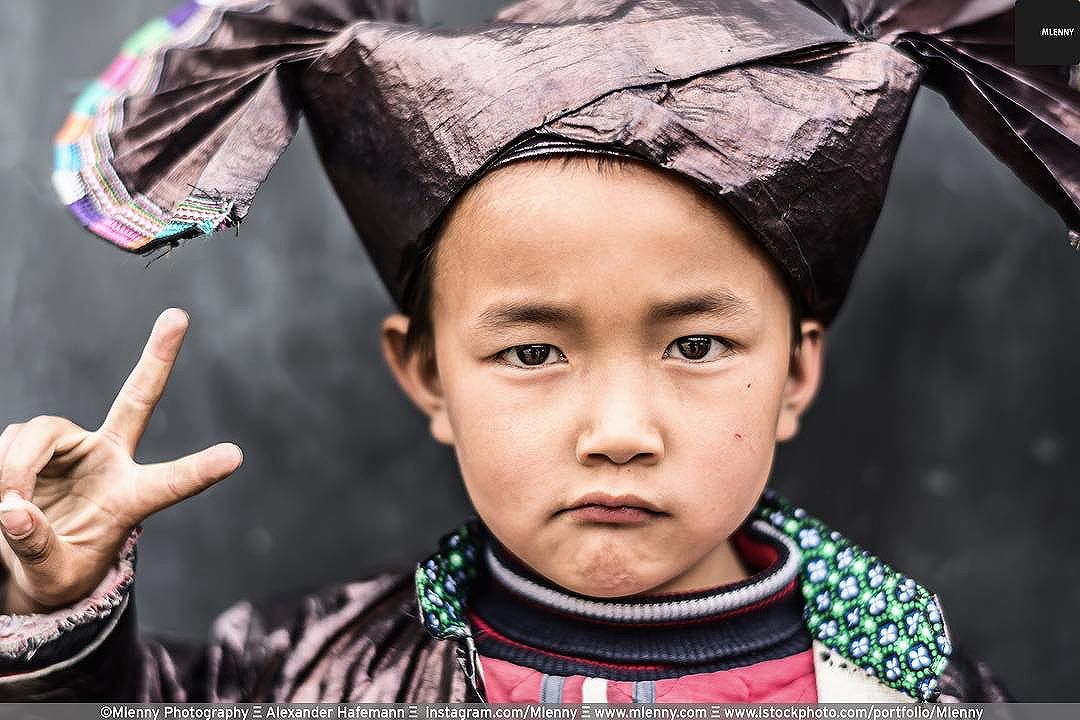 V for Victory. Chinese Boy in his traditional Dong People Costume.